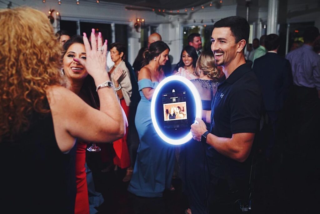 Photo booth attendant interacting with guests